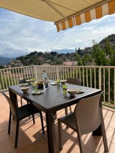 d'une table et de chaises noires sur le balcon. dans l'établissement Maison Purrussoni, à Levie