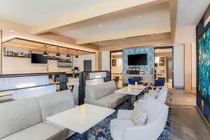 a lobby of a hotel with couches and tables at Hyatt House Davis in Davis