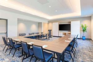 a conference room with a large table and chairs at Hyatt House Davis in Davis +22 photos