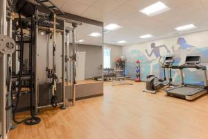 a gym with exercise equipment and a wall with a mural at Hyatt House Davis in Davis