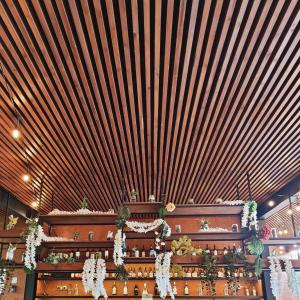 a large room with a wooden ceiling with flowers at Volcanic Charming House in Ribeira Grande