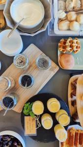 a table with different types of bread and pastries at Volcanic Charming House in Ribeira Grande