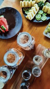 a wooden table topped with plates of food and desserts at Volcanic Charming House in Ribeira Grande