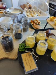a table topped with jars of food and other ingredients at Volcanic Charming House in Ribeira Grande