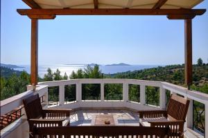 a patio with chairs and a table on a balcony at Villa Aelia in Alonnisos +4 photos