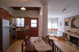 a kitchen with a table and a kitchen with a fireplace at Villa Aelia in Alonnisos