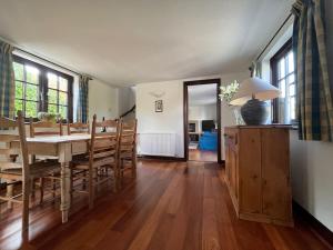 a dining room with a table and some chairs at Honeysuckle Cottage, Mickleton in Mickleton +9 photos