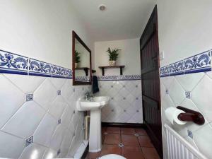 a bathroom with a sink and a toilet and a mirror at Honeysuckle Cottage, Mickleton in Mickleton
