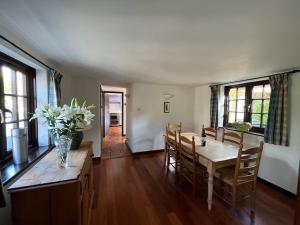 a dining room with a table and chairs at Honeysuckle Cottage, Mickleton in Mickleton