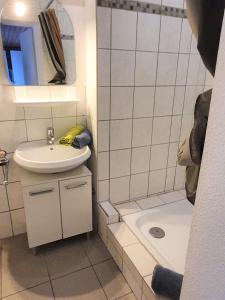 y baño pequeño con lavabo y bañera. en Apartment Nordseeblick, en Norddeich