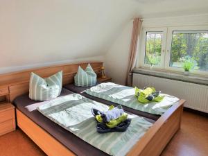 two beds with stuffed animals on them in a bedroom at Ferienhaus Nordseeblick in Norddeich