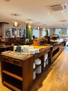 a restaurant with a counter with plates on it at MRG- Exclusive Gramado Loft 1D - 10 minutos do Centro in Gramado