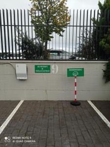 a street sign in front of a white wall at FeelFree STAYS Basoa in Donostia-San Sebastián