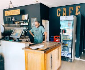 a man standing at the counter of a coffee shop at La Paix Hôtel , Restaurant in Taghazout