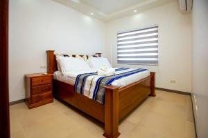 a bedroom with a large bed with a window at 3-Bedroom Apartment in Tema - Chez Akwasi in Tema