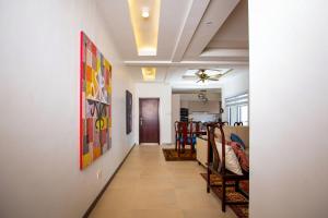 a hallway leading to a dining room and living room at 3-Bedroom Apartment in Tema - Chez Akwasi in Tema