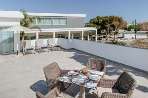 a patio with chairs and a table with plates on it at Sofianna Resort & Spa in Paphos