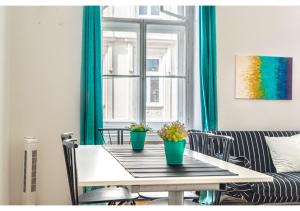 a dining room table with two potted plants on it at 4 Charming Apts. Perfect for 19 persons (6BRs) in Vienna