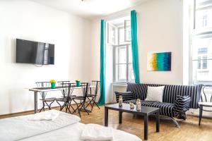 a living room with a couch and a table at 4 Charming Apts. Perfect for 19 persons (6BRs) in Vienna
