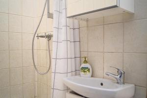 a bathroom with a sink and a shower at 4 Charming Apts. Perfect for 19 persons (6BRs) in Vienna