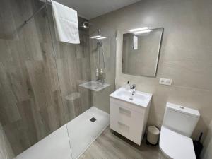 a bathroom with a toilet and a sink and a shower at DAU Centro Free Parking in Salamanca +23 photos