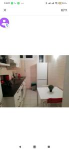 a kitchen with a white table and a white counter top at Logement tout confort Vernet les Bains à côté des thermes in Vernet-les-Bains