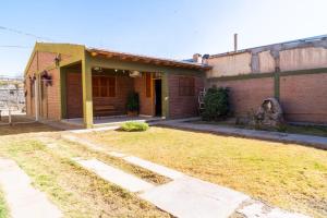 a brick house with a yard in front of it at Casa Rosa in San Juan