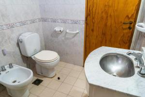 a bathroom with a toilet and a sink at Casa Rosa in San Juan