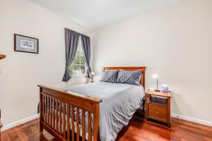 a bedroom with a wooden bed and a window at Wine Country Getaway in Windsor