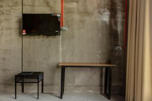 a table with a television on a wall at PADI Sentral @ Sekinchan in Sekinchan