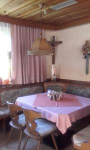 a dining room with a pink table and chairs at Ferienwohnung Hohe Wand in Heiligenblut