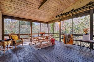 Habitación con mesa, sillas y suelo de madera. en Sparrows Nest, en Cashiers