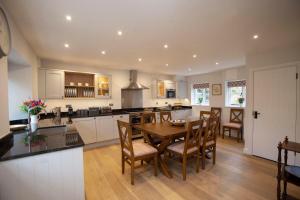 a kitchen and dining room with a table and chairs at Lucknam Park Hotel in Chippenham