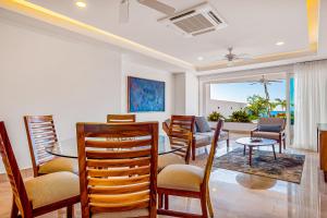 a living room with a dining table and chairs at Blue Horizon 103 in Puerto Vallarta