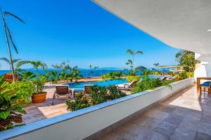 a view of the pool from the balcony of a resort at Blue Horizon 103 in Puerto Vallarta