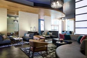 a lobby with couches and chairs and tables at Archer Hotel Falls Church in Fairfax