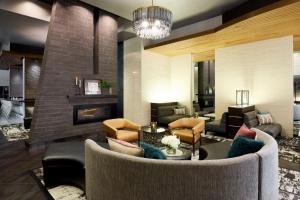 a living room with a couch and a fireplace at Archer Hotel Falls Church in Fairfax