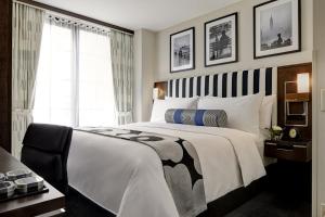 a bedroom with a large white bed and a window at Archer Hotel New York in New York