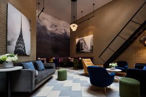 a living room filled with lots of furniture at Archer Hotel New York in New York