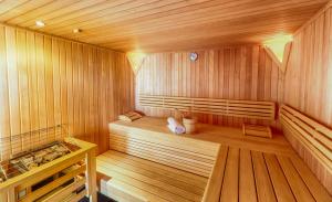 a large wooden sauna with a bench in it at Residence Bellevue by Alpin Rentals in Zell am See