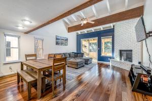 a living room with a table and a fireplace at Take Me to Tahoe in Incline Village