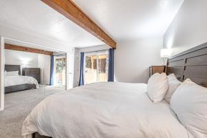a white bedroom with a large bed and a window at Take Me to Tahoe in Incline Village