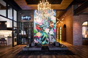 a mural on the wall of a restaurant with two tables at Archer Hotel Tysons in Tysons Corner