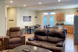 a living room with a couch and chairs and a kitchen at Balboa Bliss in McKinleyville