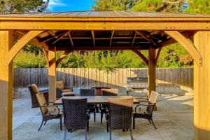 a wooden pavilion with a table and chairs on a patio at Balboa Bliss in McKinleyville