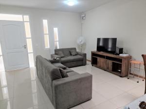 a living room with a couch and a tv at CASA - Mary Ann's House in Trujillo