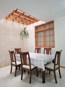 a dining room with a table and chairs at CASA - Mary Ann's House in Trujillo