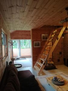 a living room with a staircase in a house at Sisaliku Puhkemaja saunaga in Luke