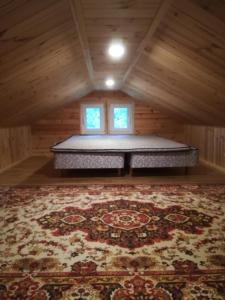 a mattress bed in a room with a rug at Sisaliku Puhkemaja saunaga in Luke