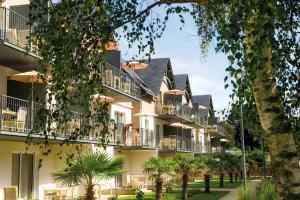 a rendering of the exterior of a building with palm trees at Résidence Vacances Bleues Les Jardins d'Arvor in Bénodet